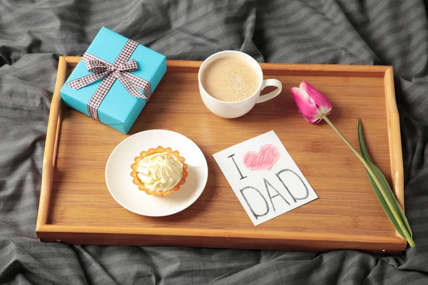 Father\'s day concept with gift and breakfast on tray. Breakfast for dad with croissant and coffee. I love dad