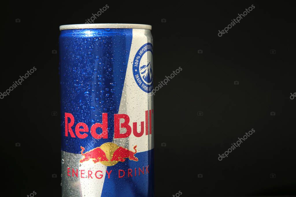 Mykolaiv, Ukraine - May 2, 2023: Red Bull Energy Drink in can with water drops on black background. Top view