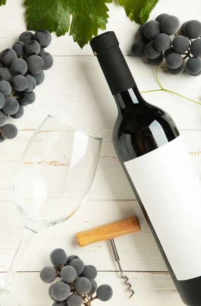 Weinflasche Und Weinglas Mit Trauben Auf Weißem Holzgrund Vertikales Foto — Stockfoto