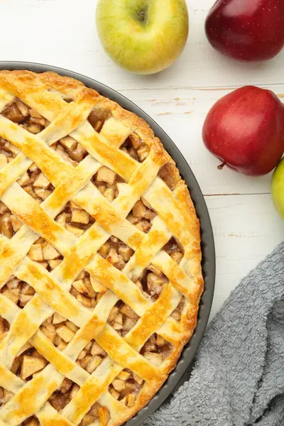 Homemade sweet american apple pie with sugar and cinnamon. Tart with apple on white background. Top view
