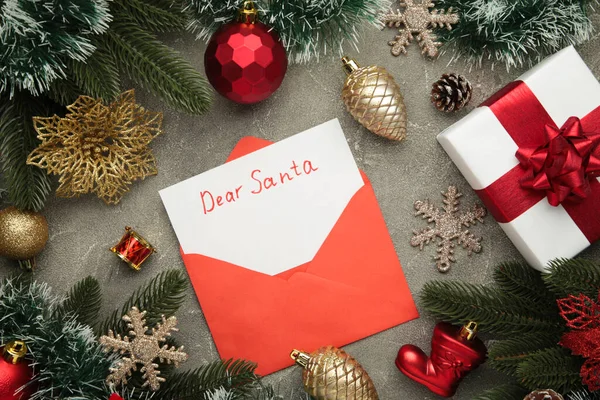 Dear Santa - letter to Santa Claus with Christmas toys on grey background. Top view