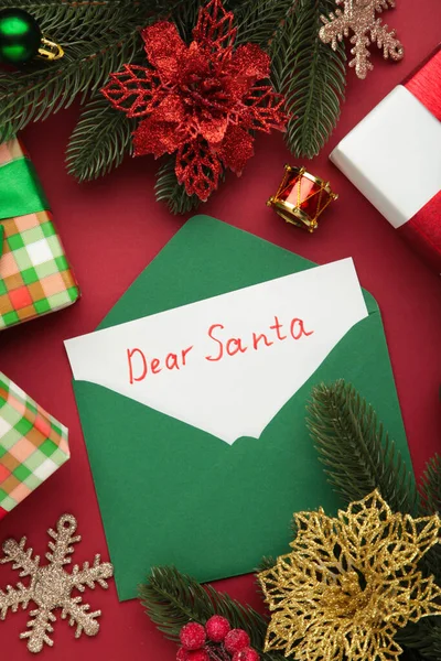 Dear Santa - letter to Santa Claus with Christmas toys on red background. Top view