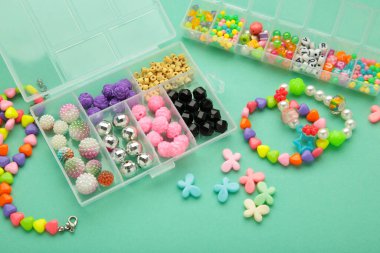 Nane arkaplanda çocuk için el yapımı mücevher yapmak için boncuklu bir kutu. Bileklik. El yapımı aksesuarlar. Üst görünüm