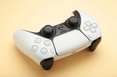 Mykolaiv, UKRAINE - July, 2024: New product from Sony, gamepad on beige background, game controller clipart