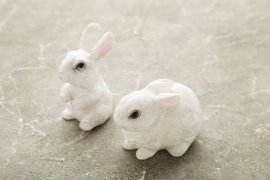 Gri arkaplanda beyaz seramik tavşan. Üst görünüm