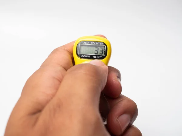 Picture of a yellow digital tally counter on a white background