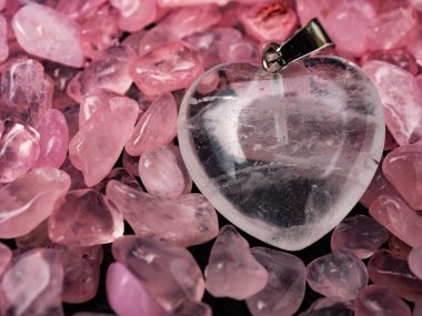 White transparent cryatal heart shaped pendant on a beautiful tumbled rose quartz gemstones