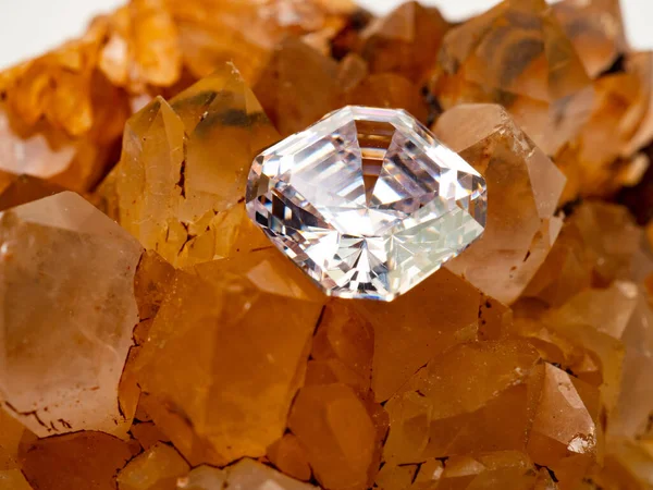 Sparkling asscher cut diamond on a rough citrine quartz stone