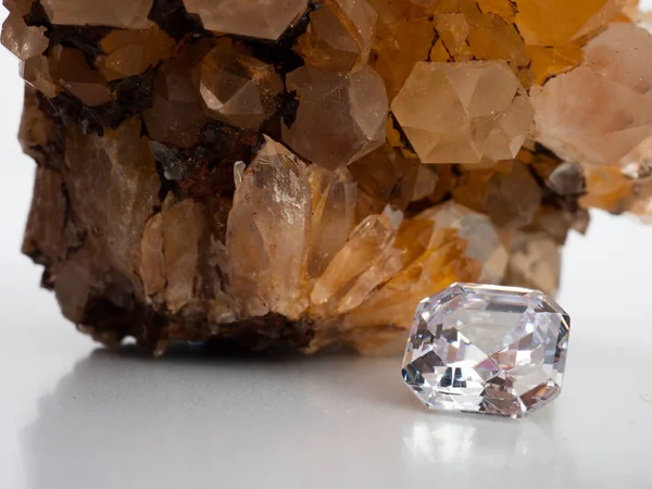 Sparkling asscher cut diamond with rough citrine stone background