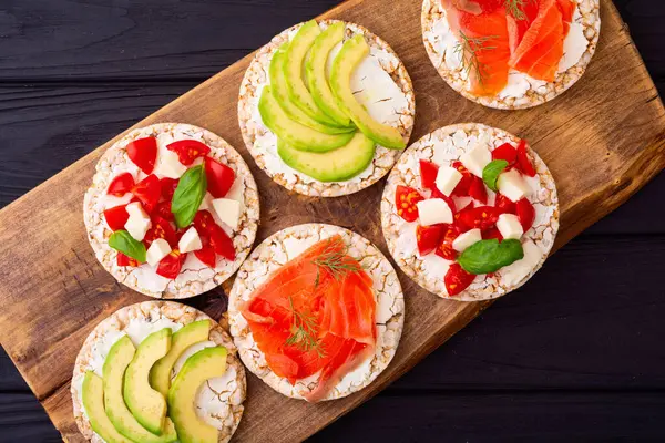 Crispbread with  salmon avocado mozzarella  and tomatoes . Healthy diet nutrion for vegan