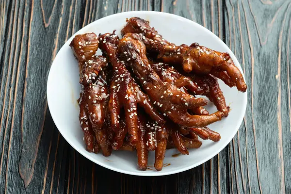 stock image Caramelized korean or Chinese chicken foots ( paws ) with sesame . Top view photography