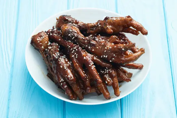 Stock image Caramelized korean or Chinese chicken foots ( paws ) with sesame . Top view photography