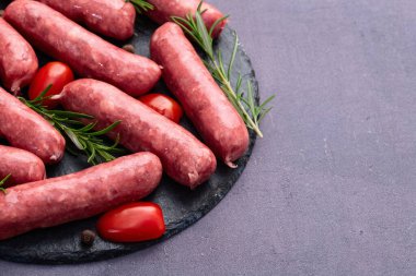 Biberiyeli çiğ et sosisi ve domates fotoğrafçılığı. Kırsal arkaplanda üst görünüm