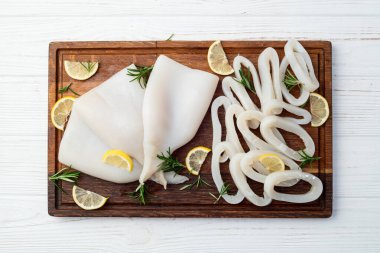 Kalamar tüpü ve yüzük fotoğrafçılığı. Kırsal arkaplanda deniz ürünleri üst görünümü