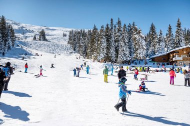 SOFIA, BULGARIA - FEBRUARY 10, 2023: People with sleds on a slope in the winter mountain .Vitosha Mountain ,Aleko Hut