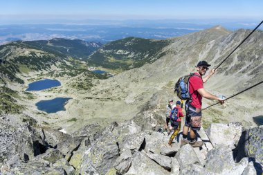 Young man hiking in the summer mountain in Bulgaria  .Rila Mountain, Musala peak 