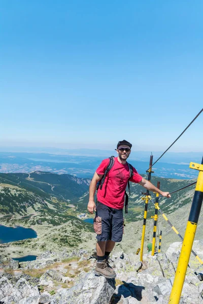 Young man hiking in the summer mountain in Bulgaria  .Rila Mountain, Musala peak