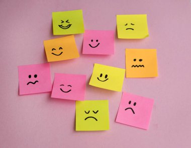 Mavi arka planda farklı duyguları olan bir sürü yapışkan not. Empati Konsepti