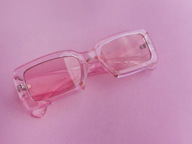 Pink sunglasses on a pink background