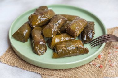 Delicious dolmades , grape leaves stuffed with rice .Greek cuisine  clipart