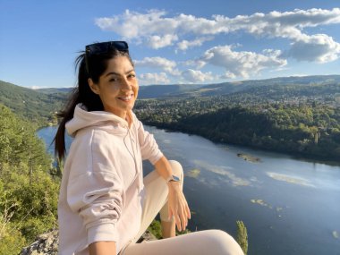 Gezgin kadın mavi bir gölün üzerinde oturuyor çarpıcı panoramik manzaralı .