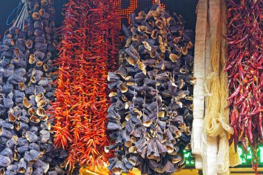 Dried aubergine eggplant vegetables hanging at strings food market