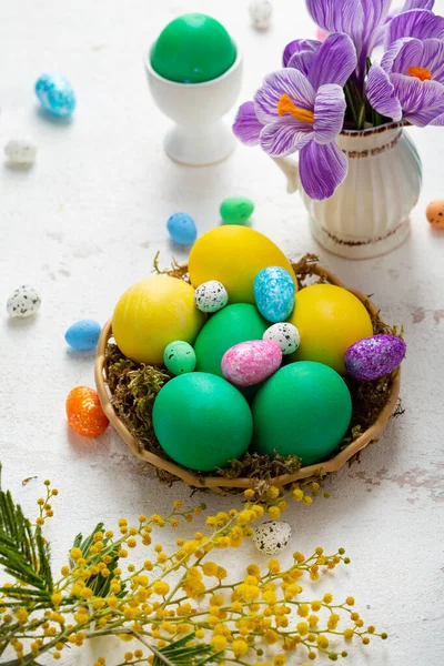 Osterfest Stillleben Mit Grünen Und Gelben Eiern Und Blumen Auf — Stockfoto