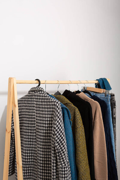 Woolen winter coats and clothes on hangers