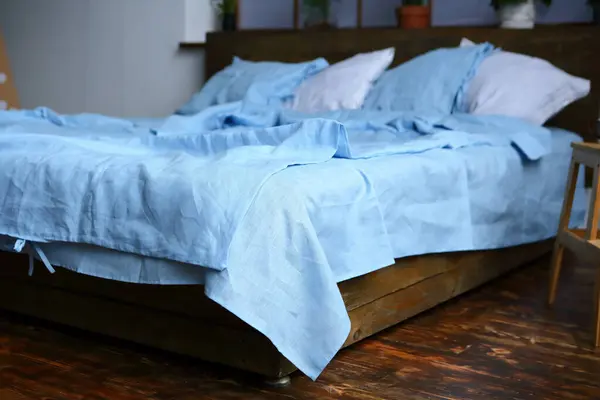 pillows on the bed white and blue linen set natural textile