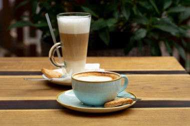 Masada bir fincan kahve ve kapuçino.