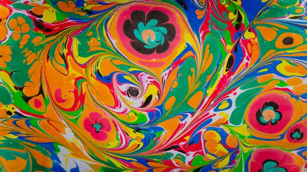 stock image Marbling, multi-colored swirled, stone-like patterns. Paint floating, spreading on the surface of a liquid. Abstract fluid art, ink in motion. Magical marble texture. Ink bloom, blast, paint explosion