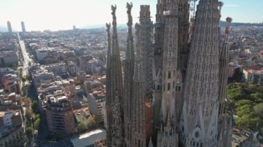 Exterior details of Basilica Sagrada Familia Cathedral - large unfinished Roman Catholic church is landmark of Eixample residential district with buildings from height. Barcelona, Catalonia, Spain.