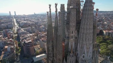 Barcelona panoramic aerial view, Eixample residential district blocks with residential buildings and Sagrada Familia Basilica Catholic Cathedral designed by architect Antoni Gaudi. Catalonia, Spain.