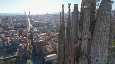 Scenic panoramic drone view of architecture from Sagrada Familia Catholic Cathedral church from the height in Barcelona. An aerial drone view of residential buildings in the city. Catalonia, Spain.