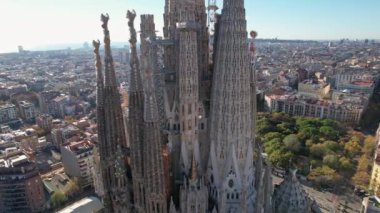 Barcelona panoramic aerial view, Eixample residential district blocks with residential buildings and Sagrada Familia Basilica Catholic Cathedral designed by architect Antoni Gaudi. Catalonia, Spain.