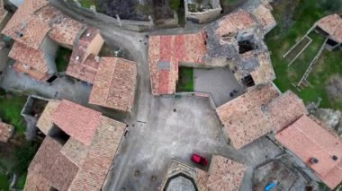 Eski ortaçağ geleneksel mimari köylerinin panoramik insansız hava aracı görüntüsü ve Luzas ve Romanesk San Cristobal kiliselerinin çatı kiremitleri. Huesca ili, Aragon, İspanya. 4K