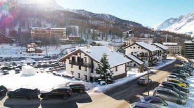 Kayak pistlerindeki panoramik hava aracı manzarası, dağ kayağı ve popüler tatil köyü. Aosta Vadisi 'ndeki Alplerdeki İtalyan kayak merkezi. Kış manzarası. İtalya, Breuil Cervinia. 4K video