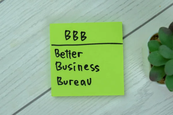 stock image Concept of BBB - Better Business Bureau write on sticky notes isolated on Wooden Table.