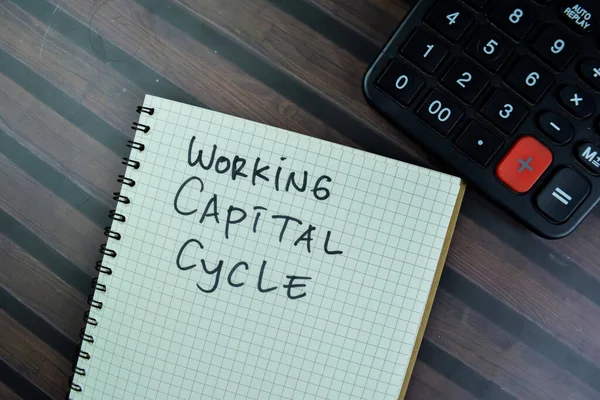 Concept of Working Capital Cycle write on a book isolated on Wooden Table.