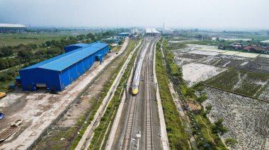 Tren istasyonundaki yüksek hızlı turuncu trenin hava görüntüsü. Hızlı tren Jakarta-Bandung. Bandung, Endonezya, 22 Kasım 2022
