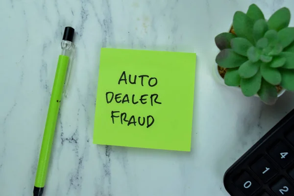 Concept of Auto Dealer Fraud write on sticky notes isolated on Wooden Table.