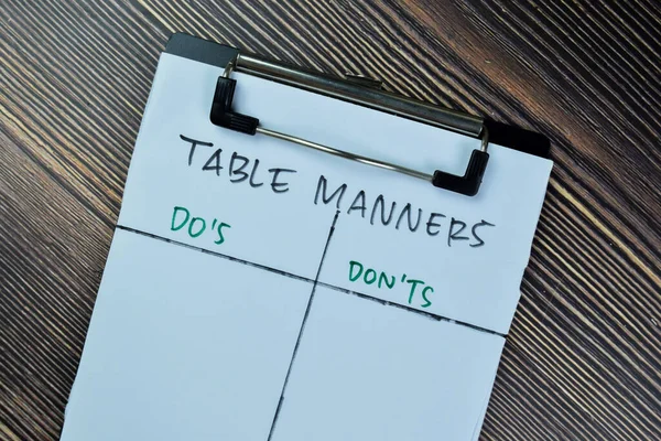 Concept of Table Manners with Do\'s and Don\'ts write on paperwork isolated on Wooden Table.