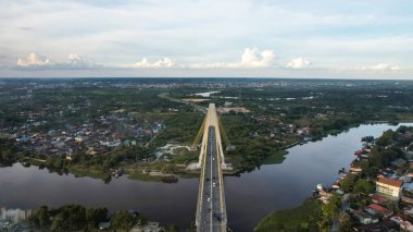 Aerial view of Siak Bridge IV (Abdul Jalil Alamuddin Syah Bridge) above Siak River (Sungai Siak) in Pekanbaru top view. Pekanbaru, Indonesia, January 25, 2023