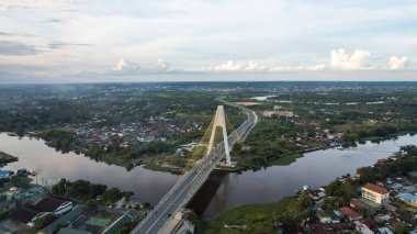 Aerial view of Siak Bridge IV (Abdul Jalil Alamuddin Syah Bridge) above Siak River (Sungai Siak) in Pekanbaru top view. Pekanbaru, Indonesia, January 25, 2023