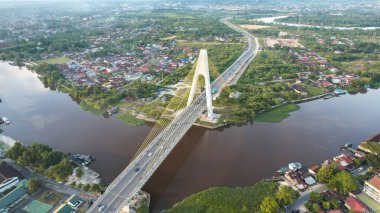 Aerial view of Siak Bridge IV (Abdul Jalil Alamuddin Syah Bridge) above Siak River (Sungai Siak) in Pekanbaru top view. Pekanbaru, Indonesia, January 25, 2023