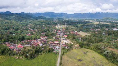 Aerial view of panorama of beautiful countryside of Bukittinggi. wonderful springtime landscape in mountains. grassy field and rolling hills. rural scenery. Bukittinggi, Indonesia, January 28, 2023