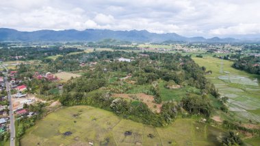 Aerial view of panorama of beautiful countryside of Bukittinggi. wonderful springtime landscape in mountains. grassy field and rolling hills. rural scenery. Bukittinggi, Indonesia, January 28, 2023