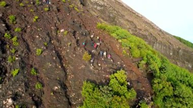 Happy hiker winning reaching life goal, success, freedom and happiness, achievement in mountains. Mount Slamet. Central Java, Indonesia. February 7, 2023