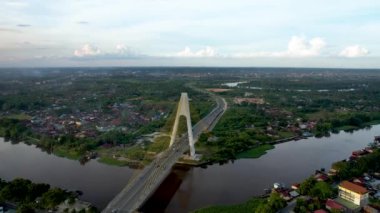 Aerial view of Siak Bridge IV (Abdul Jalil Alamuddin Syah Bridge) above Siak River (Sungai Siak) in Pekanbaru top view. Pekanbaru, Indonesia, February 22, 2023
