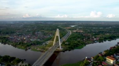 Aerial view of Siak Bridge IV (Abdul Jalil Alamuddin Syah Bridge) above Siak River (Sungai Siak) in Pekanbaru top view. Pekanbaru, Indonesia, February 22, 2023